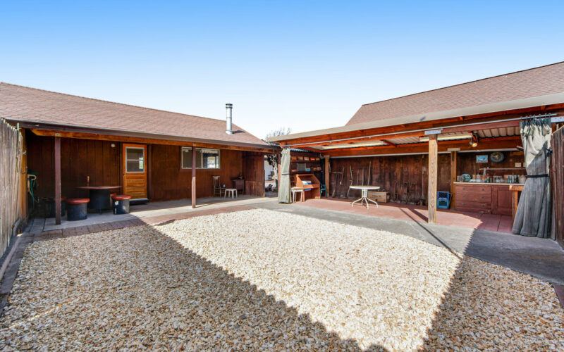 Gravel courtyard between wood-sided buildings at 720 Cleveland Lane