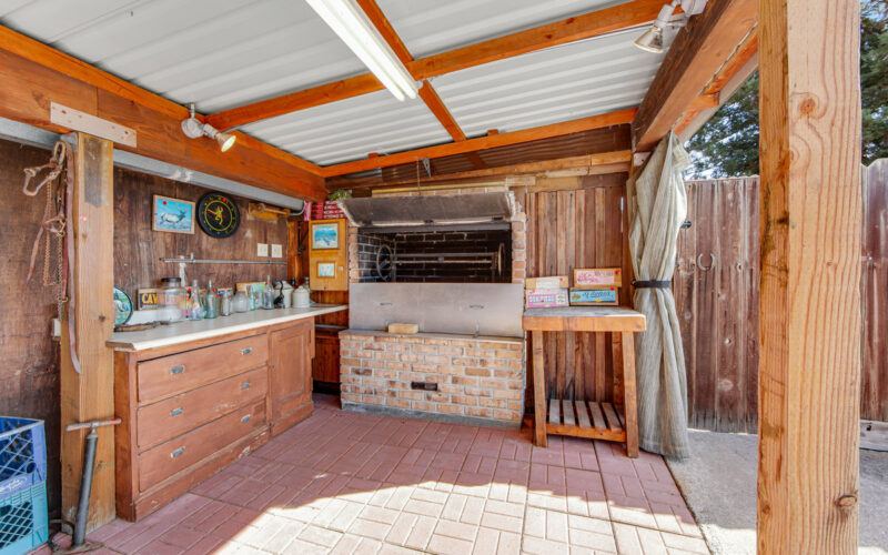 Covered outdoor counter and brick barbecue at 720 Cleveland Lane