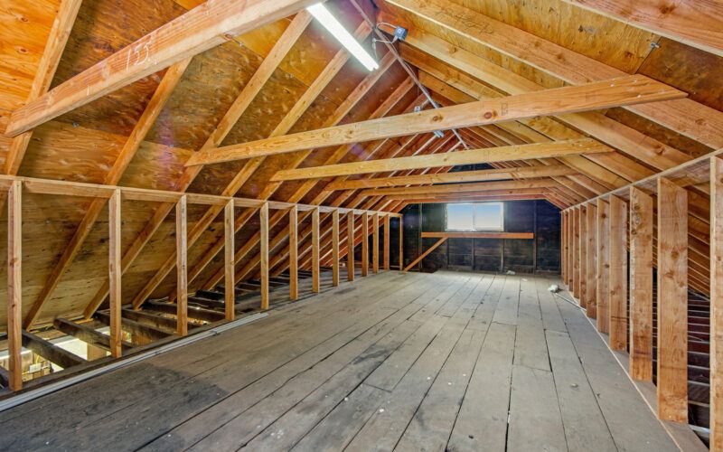 Exposed rafters and plank floor in the barn loft at 720 Cleveland Lane